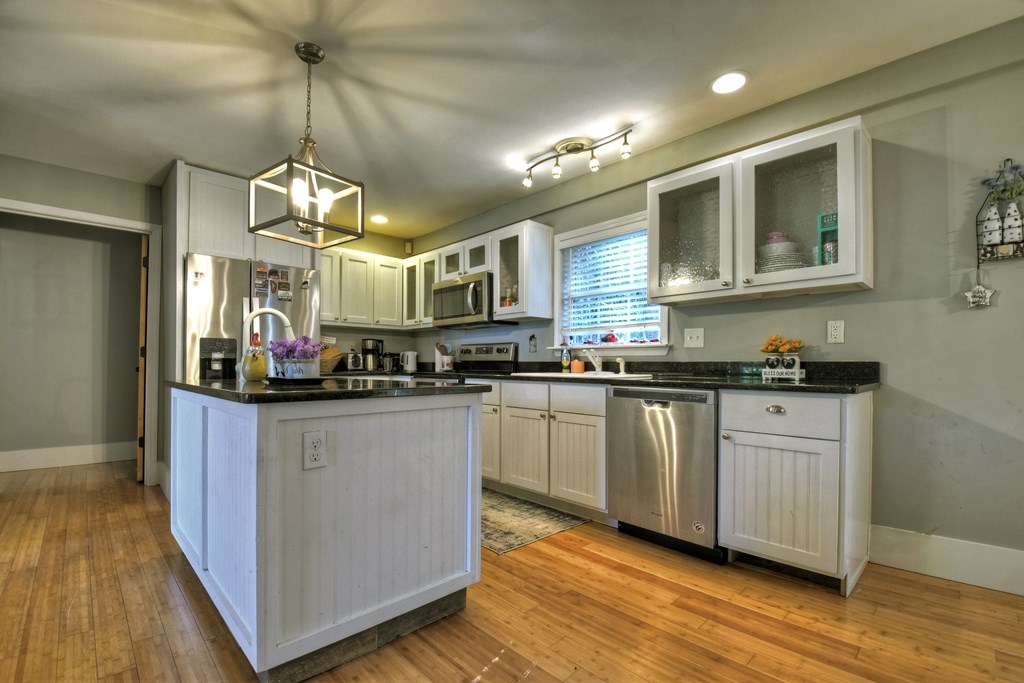 10266 Boardtown Road Cherry Log, GA 30522 - Photo 18 of 40 a kitchen with stainless steel appliances granite countertop a sink cabinets and wooden floor
