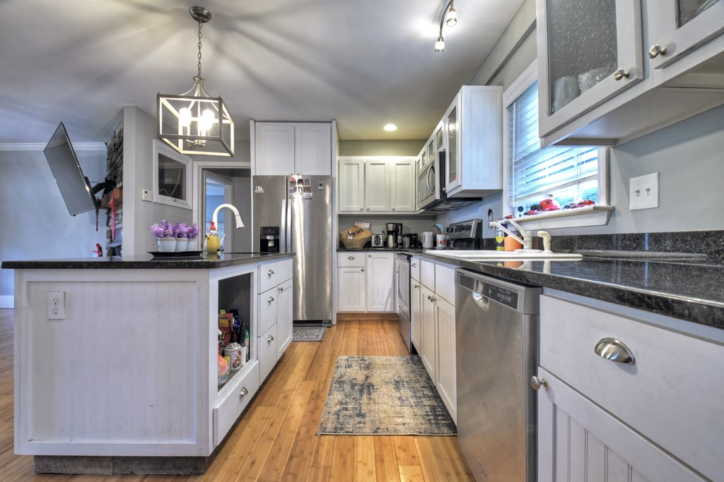 10266 Boardtown Road Cherry Log, GA 30522 - Photo 19 of 40 a kitchen with stainless steel appliances granite countertop a sink a stove top oven a counter space and cabinets