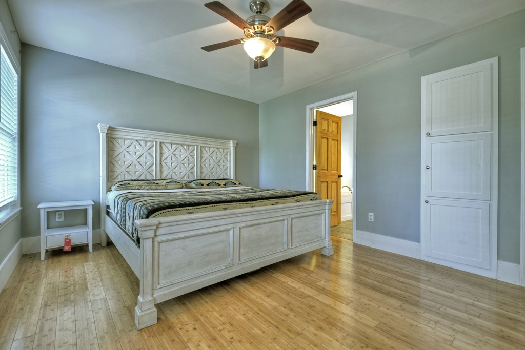 10266 Boardtown Road Cherry Log, GA 30522 - Photo 21 of 40 a bedroom with a bed and a chandelier