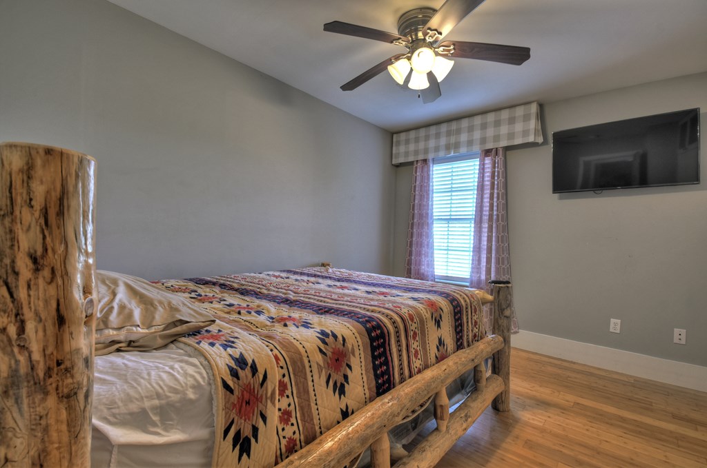 10266 Boardtown Road Cherry Log, GA 30522 - Photo 27 of 40 a bedroom with a bed and a flat screen tv