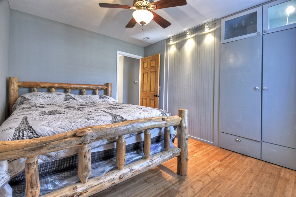 10266 Boardtown Road Cherry Log, GA 30522 - Photo 28 of 40 a bedroom with a bed and a chandelier