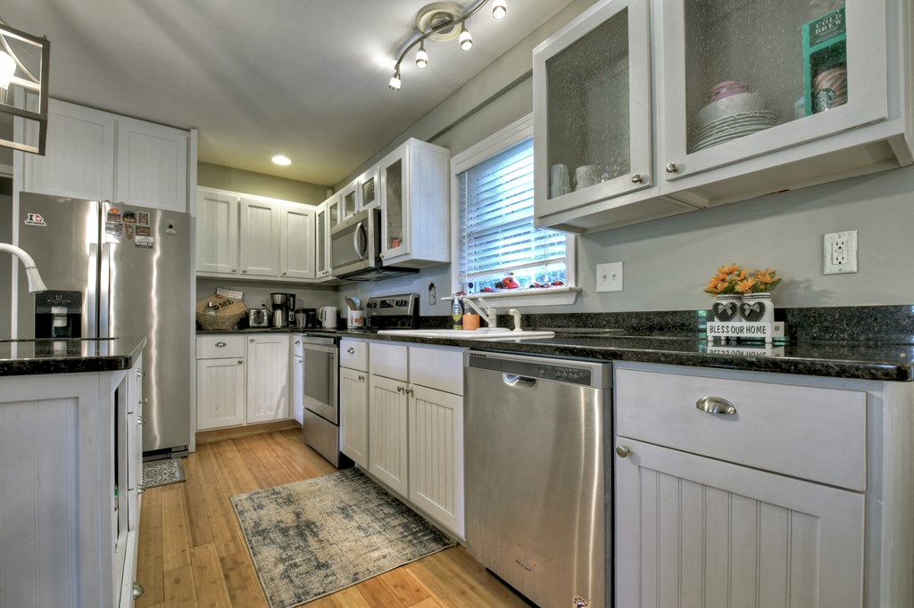 10266 Boardtown Road Cherry Log, GA 30522 - Photo 3 of 40 a kitchen with granite countertop a sink stainless steel appliances and cabinets