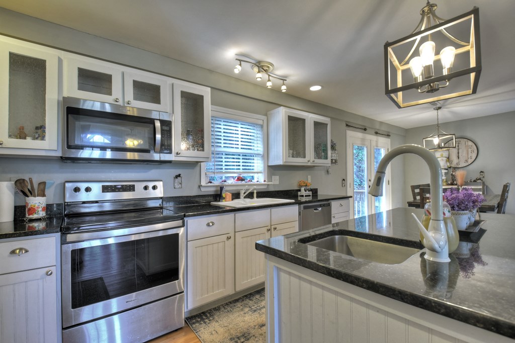 10266 Boardtown Road Cherry Log, GA 30522 - Photo 7 of 40 a kitchen with kitchen island granite countertop a sink stainless steel appliances and cabinets