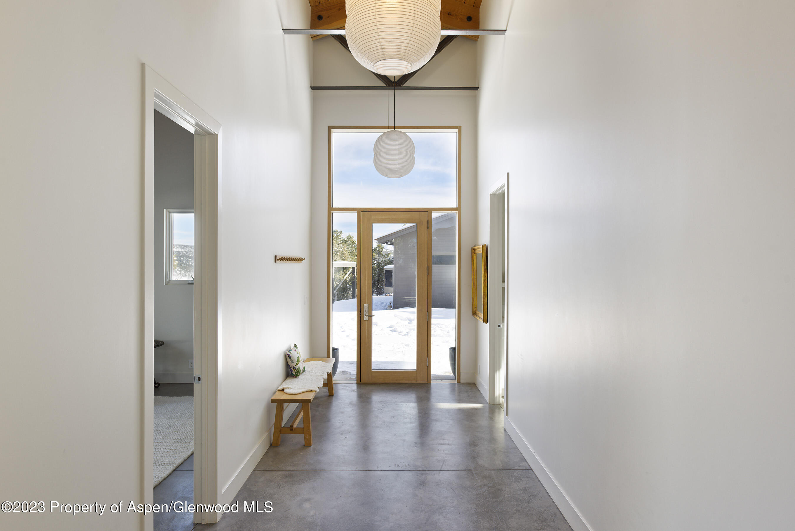 89 Sage Swale Road Carbondale, CO 81623 - Photo 19 of 23 a hallway with a door and a rug