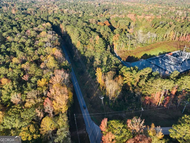 an aerial view of house with yard and mountain view in back