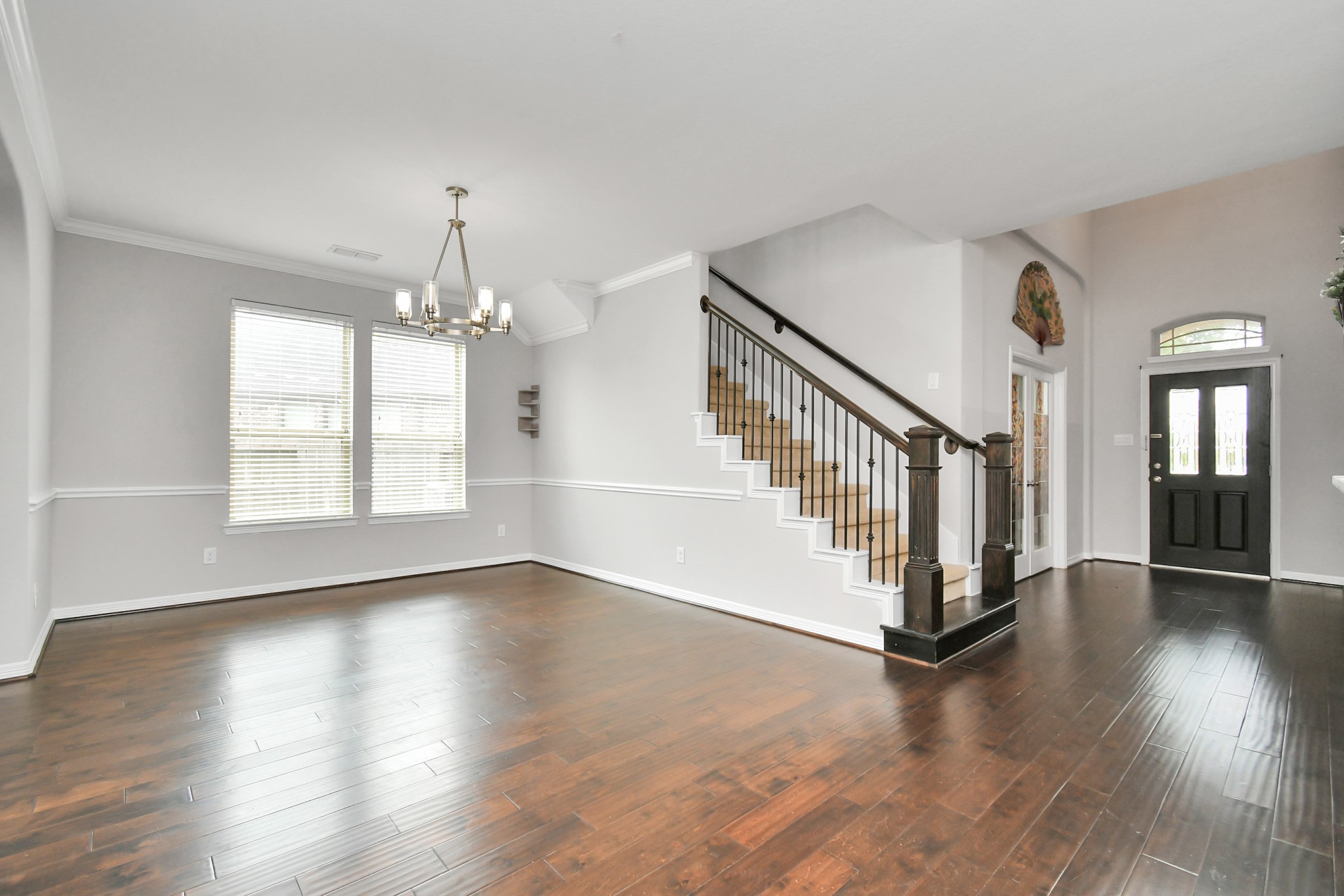 3803 May Ridge Lane Sugar Land, TX 77479 - Photo 11 of 47 a view of an entryway with wooden floor stairs and a chandelier
