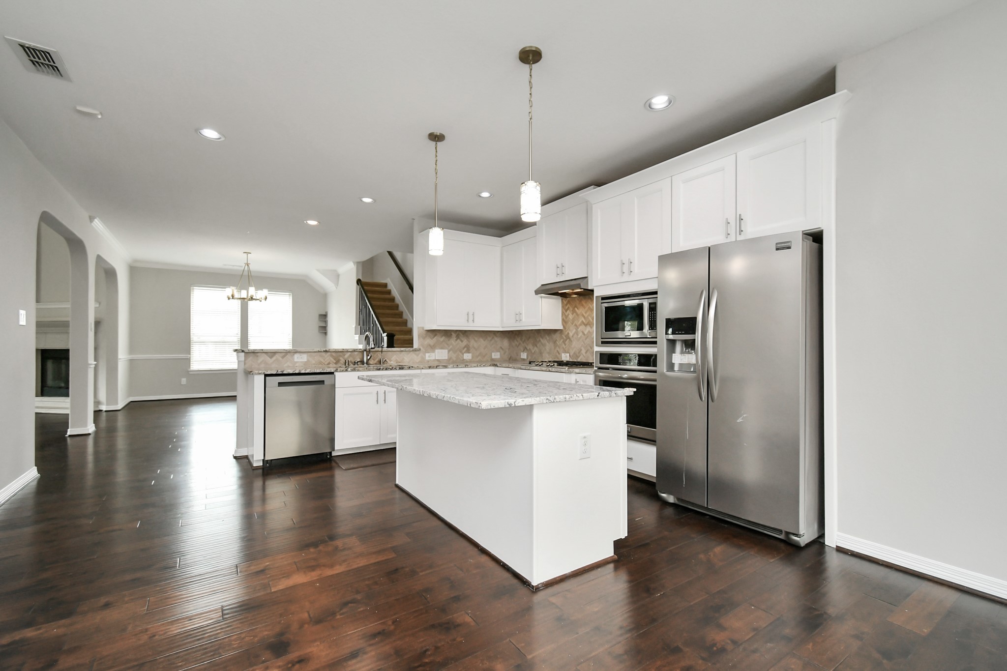 3803 May Ridge Lane Sugar Land, TX 77479 - Photo 18 of 47 a kitchen with stainless steel appliances kitchen island granite countertop a refrigerator a stove a sink and a oven
