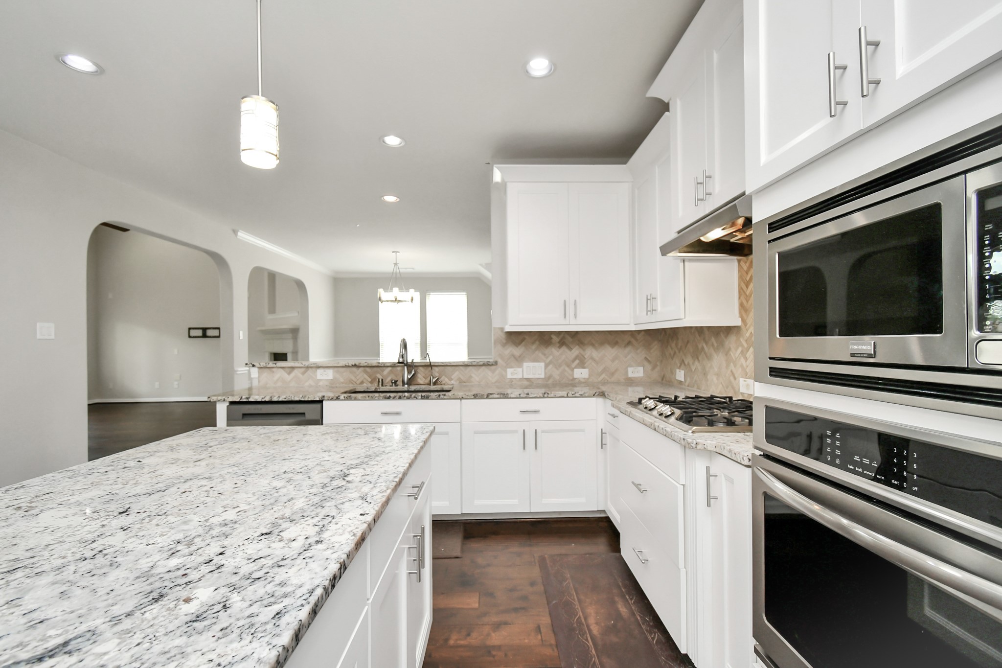 3803 May Ridge Lane Sugar Land, TX 77479 - Photo 23 of 47 a kitchen with a stove sink and microwave