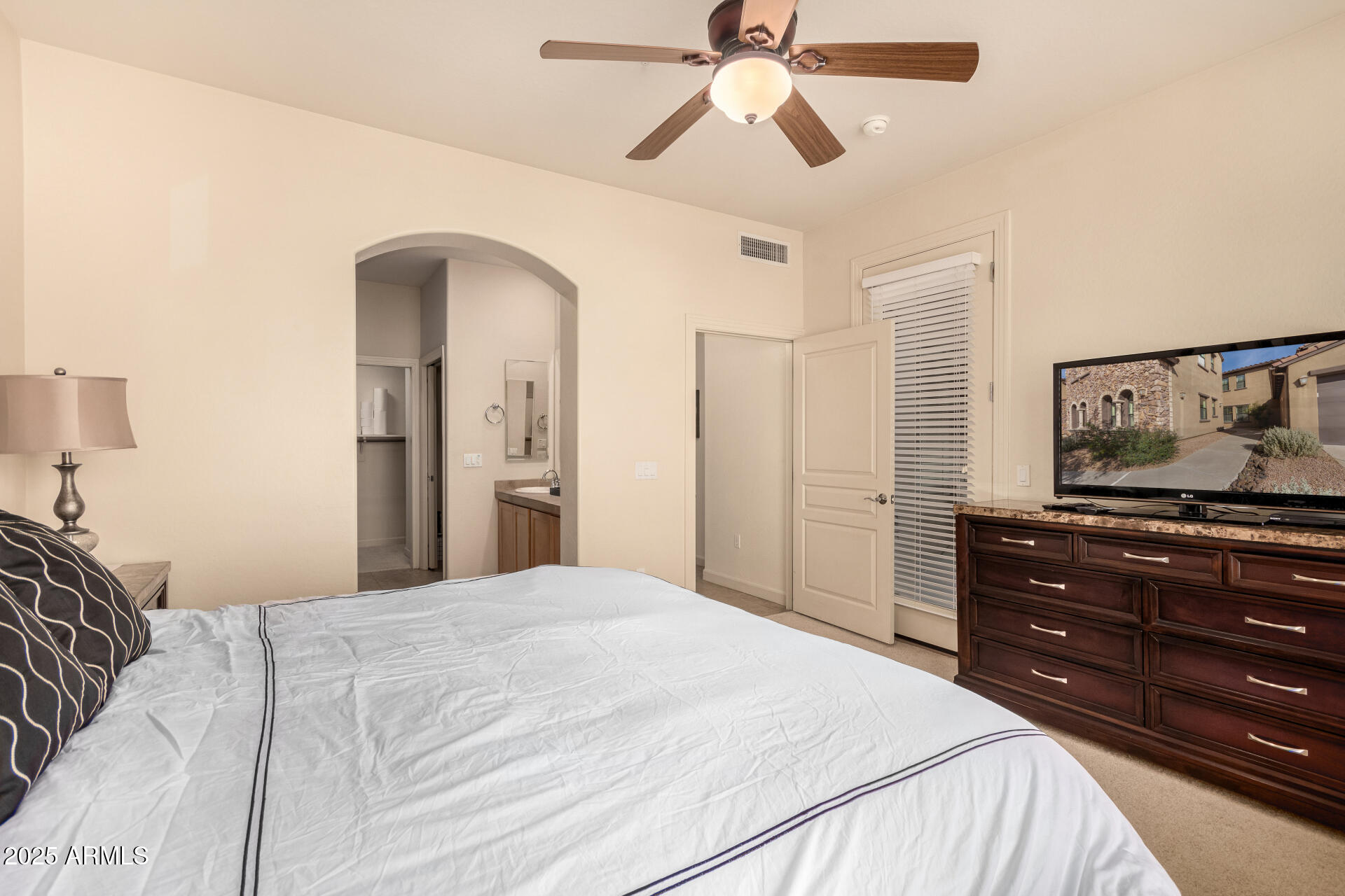 20750 North 87th Street, Unit 1065 Scottsdale, AZ 85255 - Photo 12 of 29 a bedroom with a bed and a chandelier