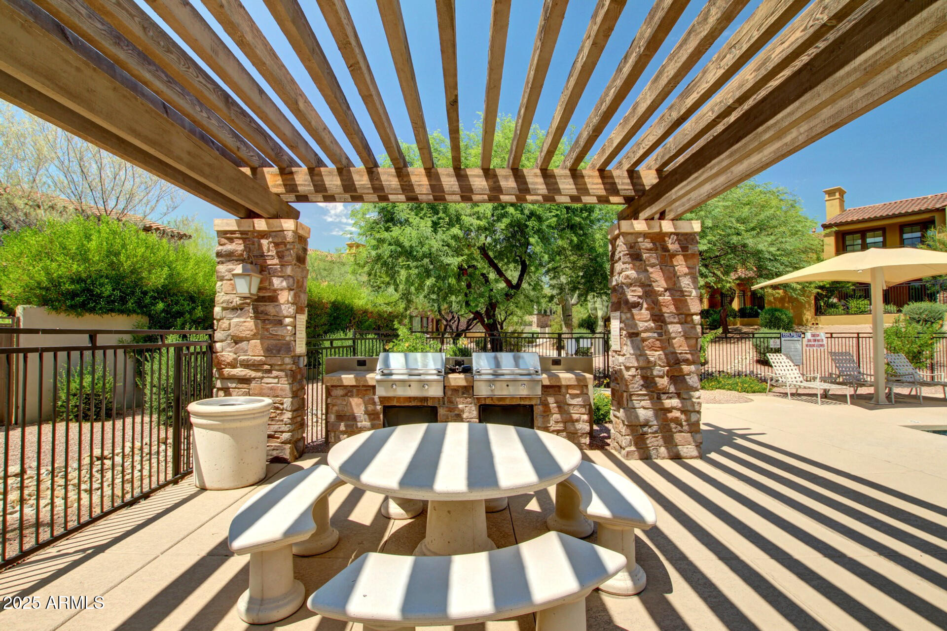 20750 North 87th Street, Unit 1065 Scottsdale, AZ 85255 - Photo 23 of 29 a view of a patio with table and chairs and wooden floor