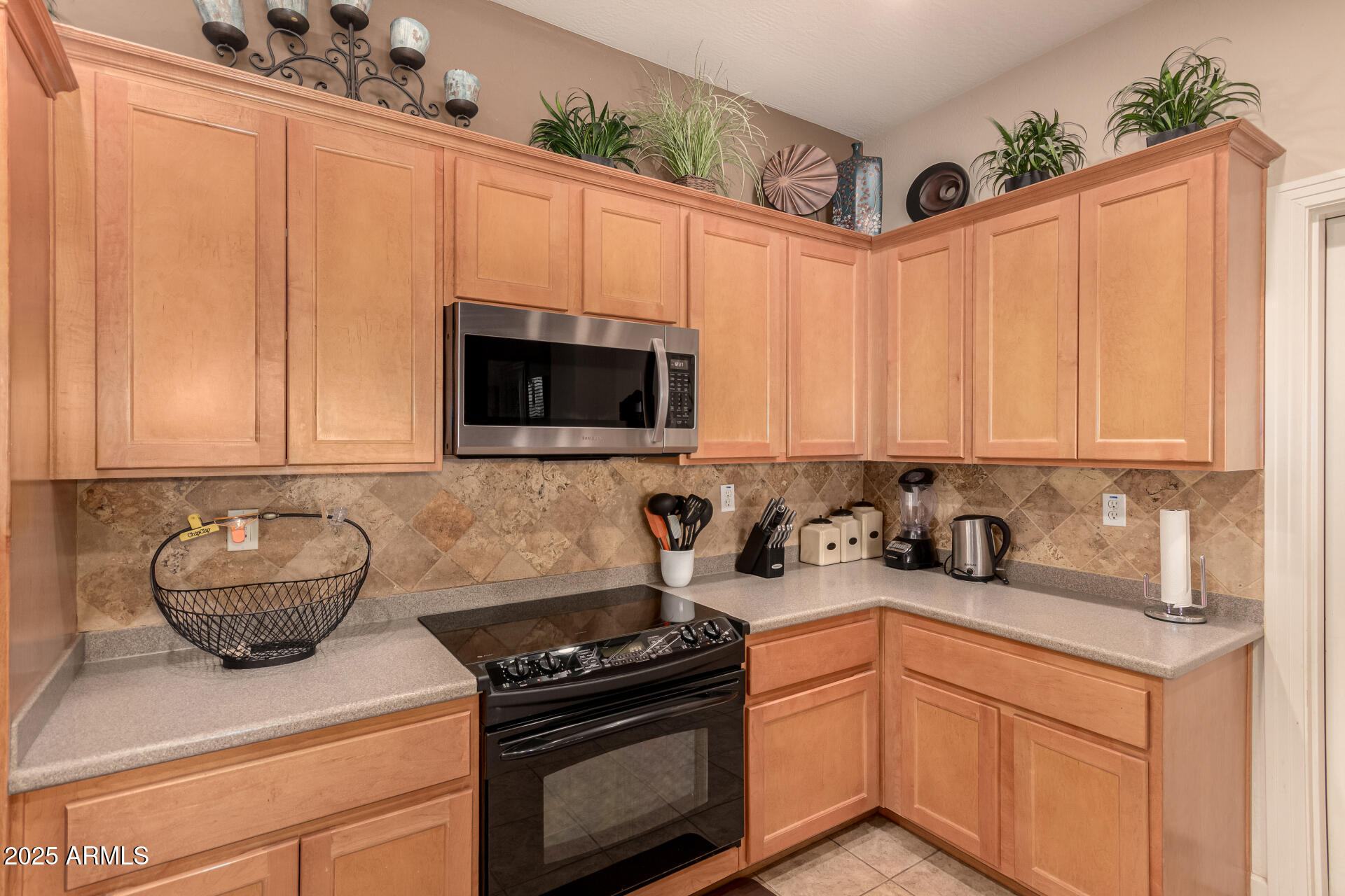 20750 North 87th Street, Unit 1065 Scottsdale, AZ 85255 - Photo 8 of 29 a kitchen with stainless steel appliances a stove a sink and a microwave
