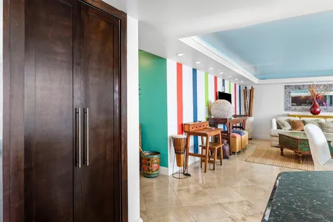 a balcony view with a large window and sitting space