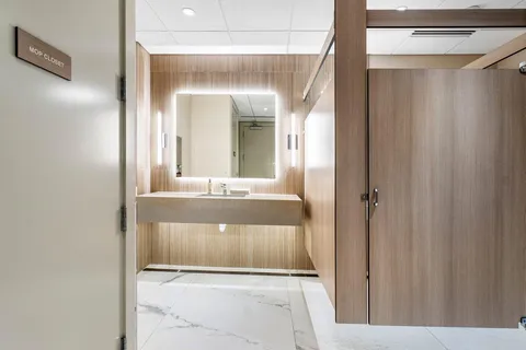 a kitchen with stainless steel appliances granite countertop a refrigerator a sink a stove with wooden floor