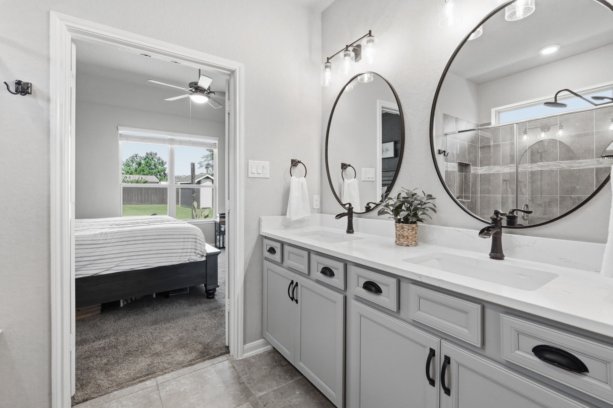 4334 Umber Shadow Drive Spring, TX 77386 - Photo 16 of 45 Primary bathroom vanity area features dual sinks, abundant storage, oversized mirrors, and a seamless connection to the adjoining bath and bedroom.