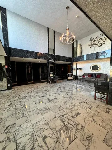 a living room with fireplace furniture and a chandelier