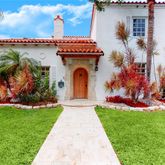 a front view of a house with garden