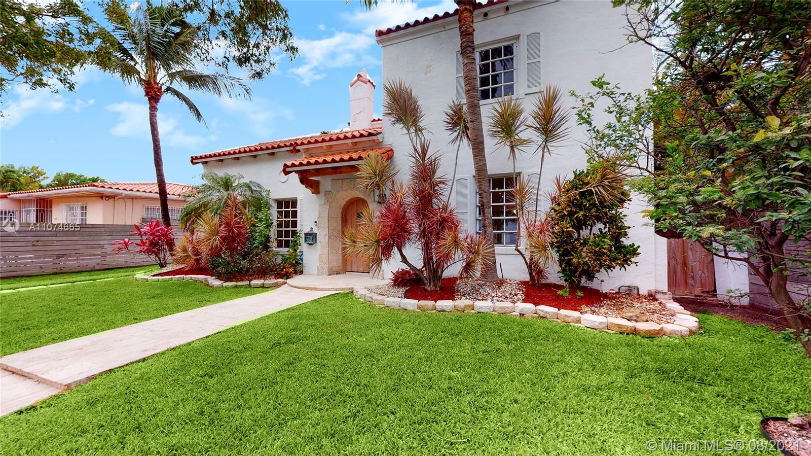 2032 Alton Road Miami Beach, FL 33140 - Photo 2 of 35 a front view of a house with garden