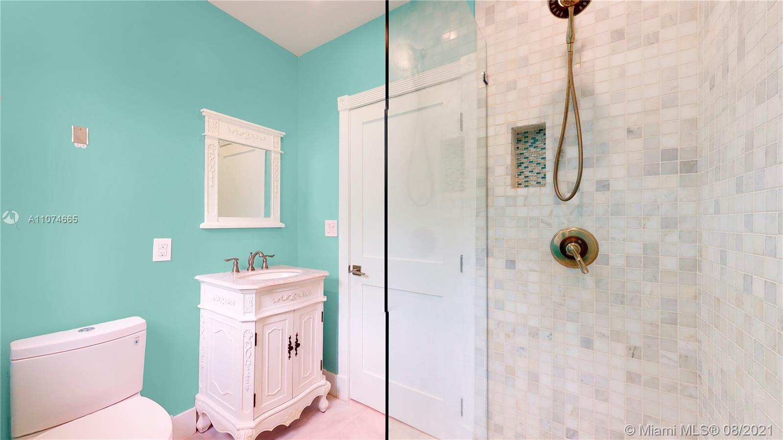 2032 Alton Road Miami Beach, FL 33140 - Photo 11 of 35 a bathroom with a sink a toilet and shower
