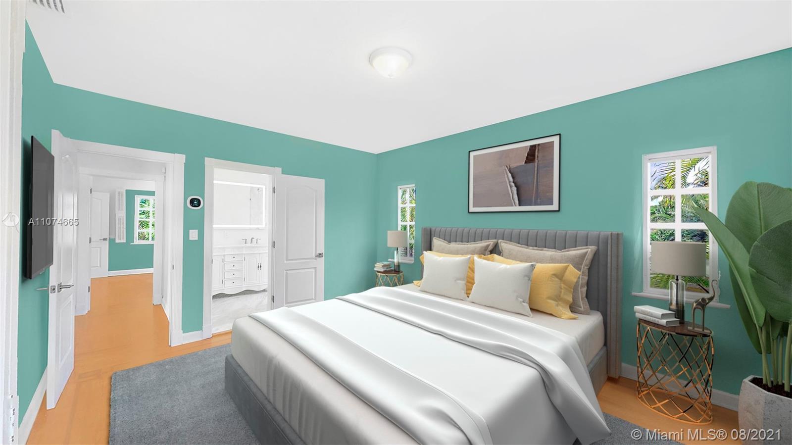 2032 Alton Road Miami Beach, FL 33140 - Photo 16 of 35 a bedroom with a bed and a mirror