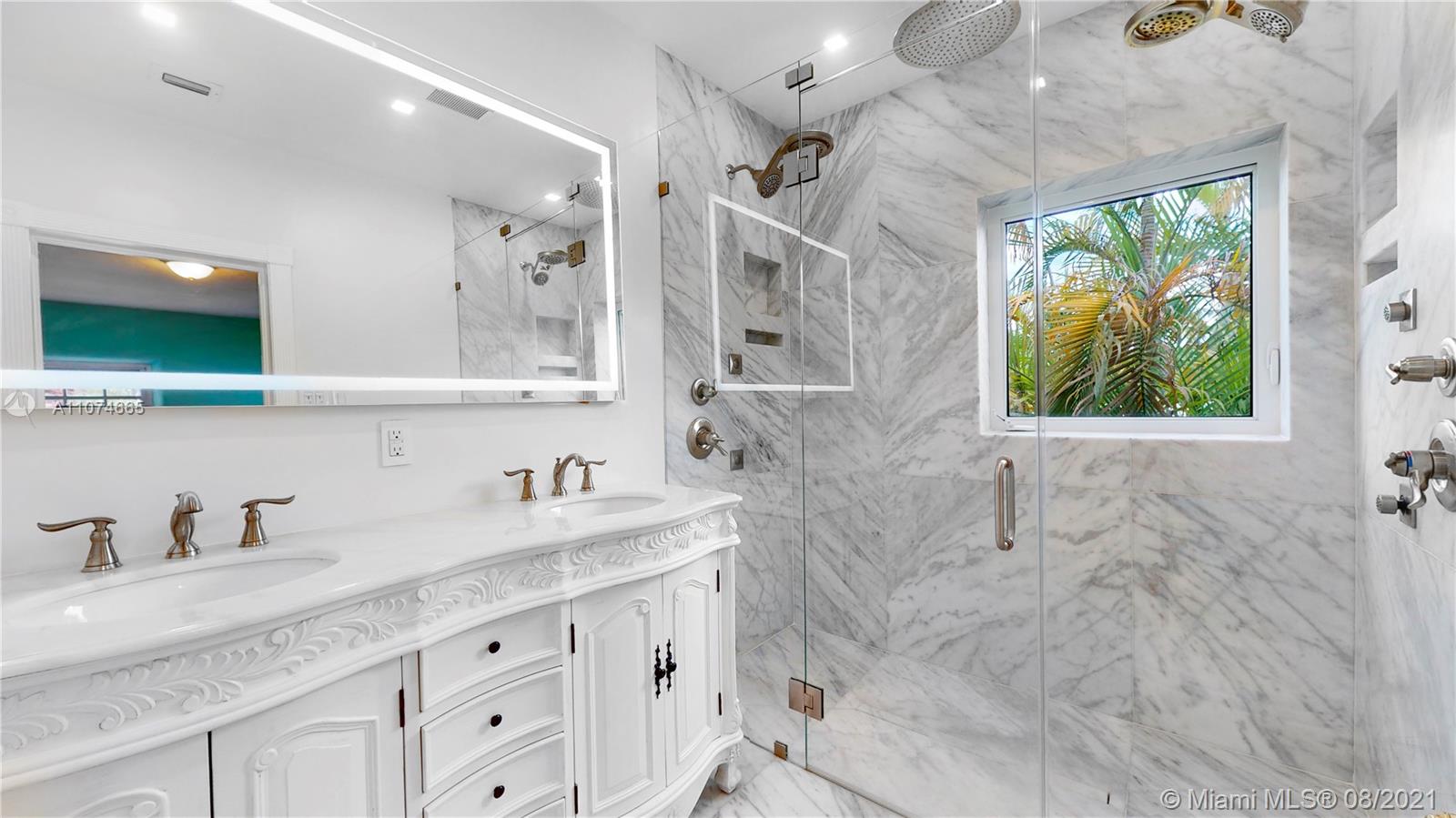 2032 Alton Road Miami Beach, FL 33140 - Photo 19 of 35 a bathroom with a granite countertop sink mirror and window