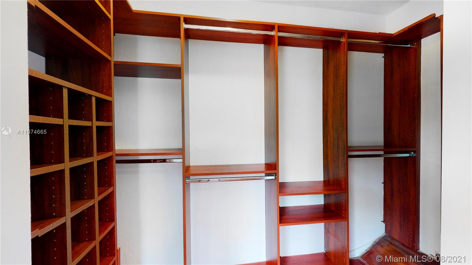 2032 Alton Road Miami Beach, FL 33140 - Photo 20 of 35 a view of walk in closet with clothes and shoes
