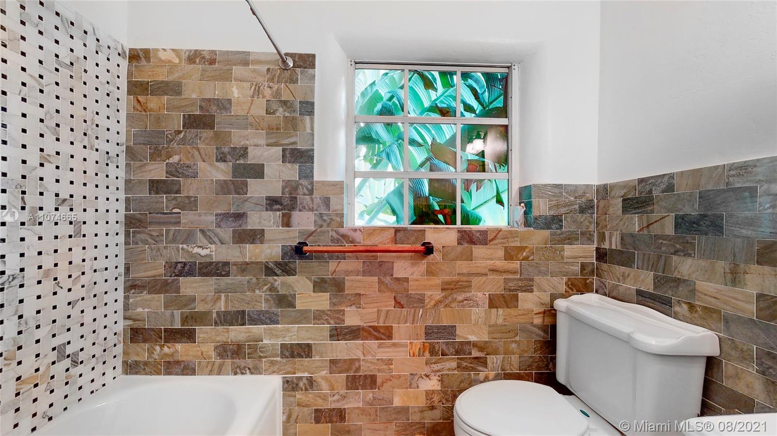 2032 Alton Road Miami Beach, FL 33140 - Photo 23 of 35 a bathroom with a toilet and a shower