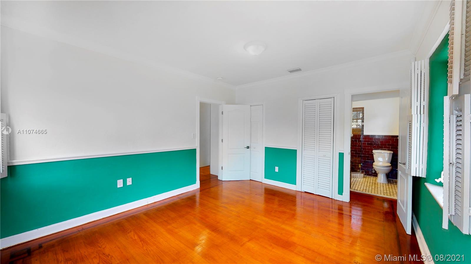 2032 Alton Road Miami Beach, FL 33140 - Photo 24 of 35 a view of a room with kitchen cabinetry and a wooden floor