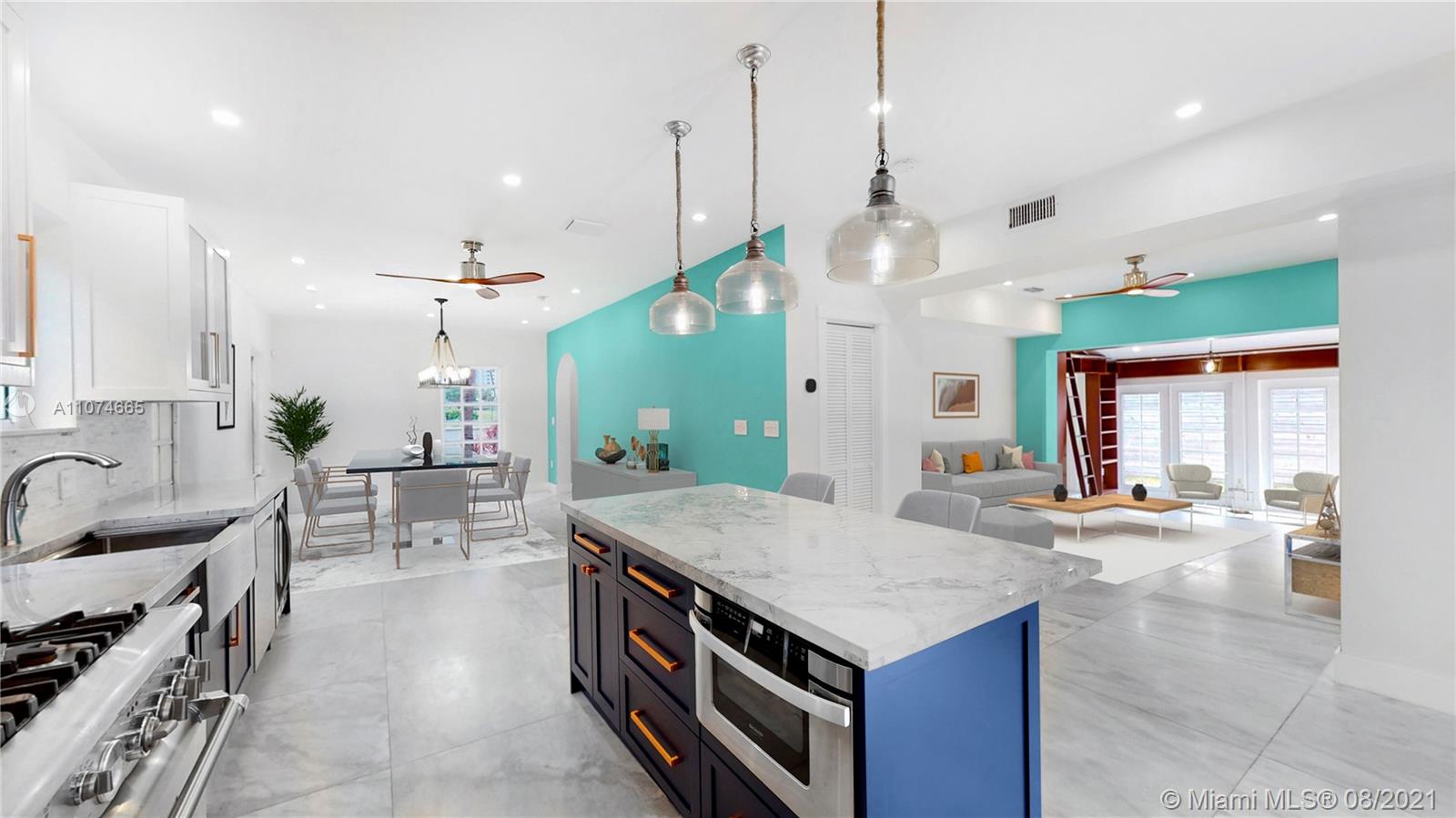 2032 Alton Road Miami Beach, FL 33140 - Photo 4 of 35 a kitchen with a stove kitchen island and couches with wooden floor