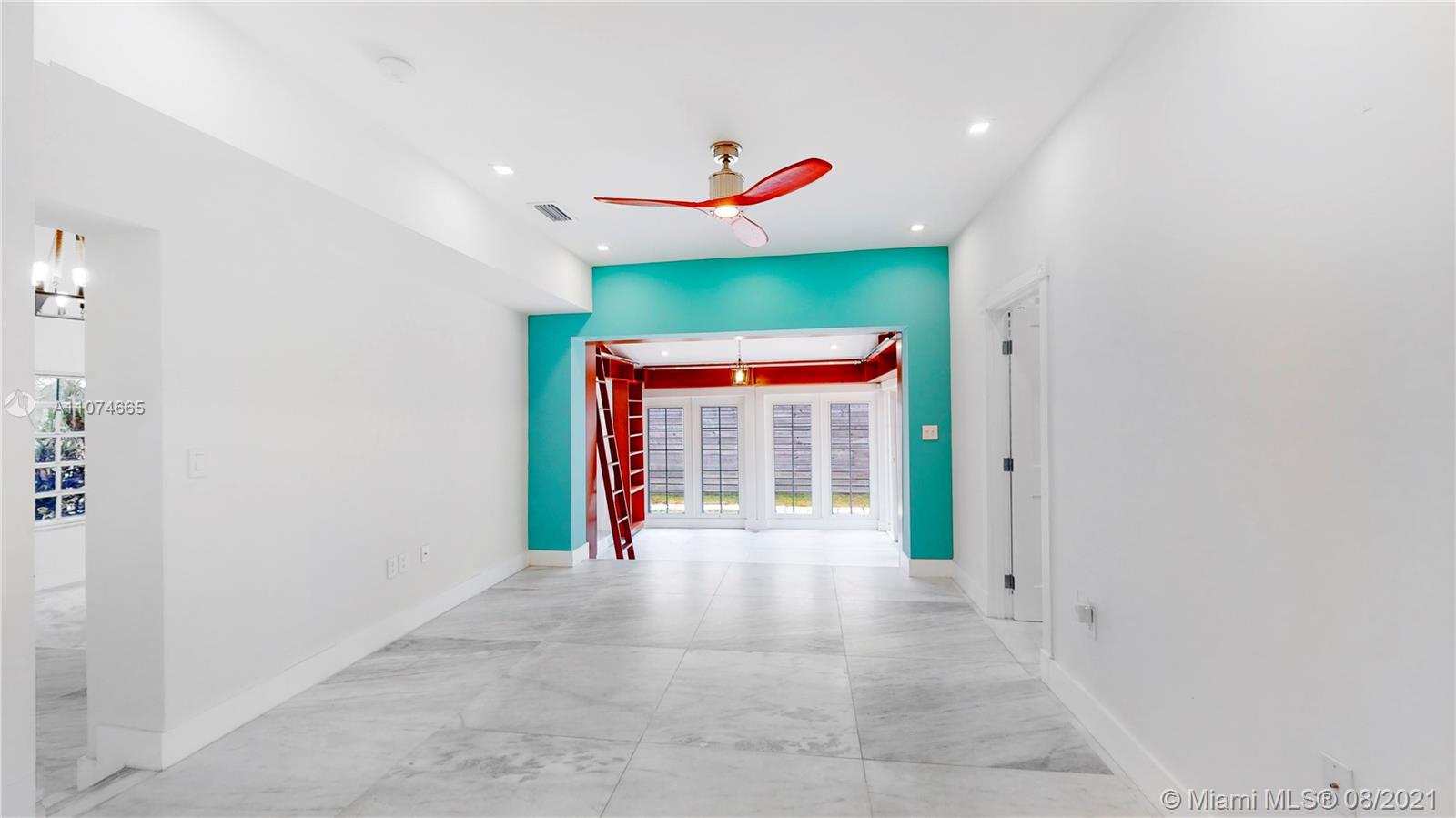 2032 Alton Road Miami Beach, FL 33140 - Photo 10 of 35 a view of a hallway with a chandelier