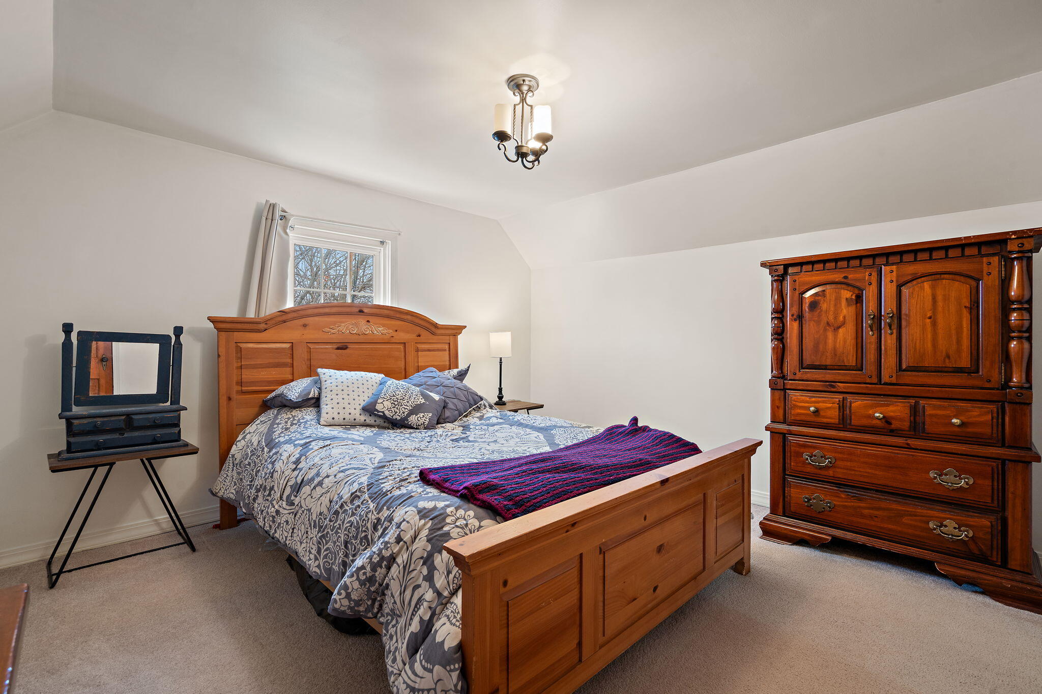 601 Azalea Street Southeast Demotte, IN 46310 - Photo 14 of 29 a bedroom with a bed and a chandelier