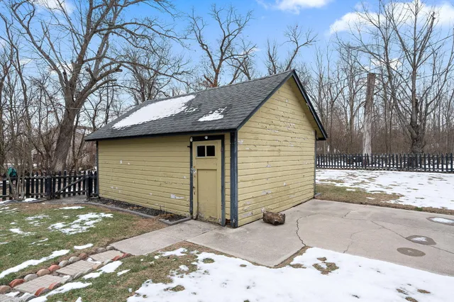 a view of a house with a yard covered in snow