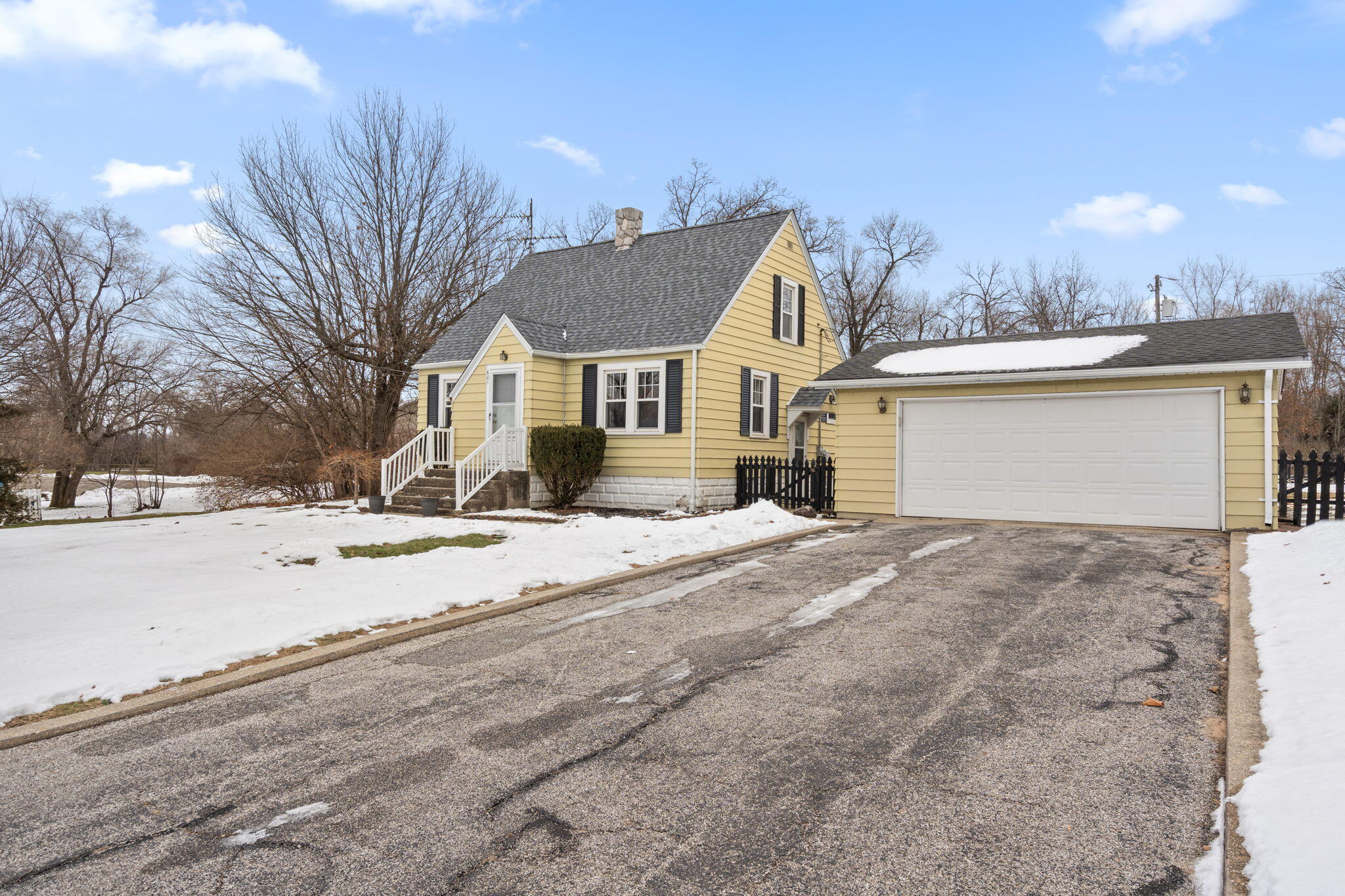 601 Azalea Street Southeast Demotte, IN 46310 - Photo 29 of 29 a view of a white house with a snow on the road