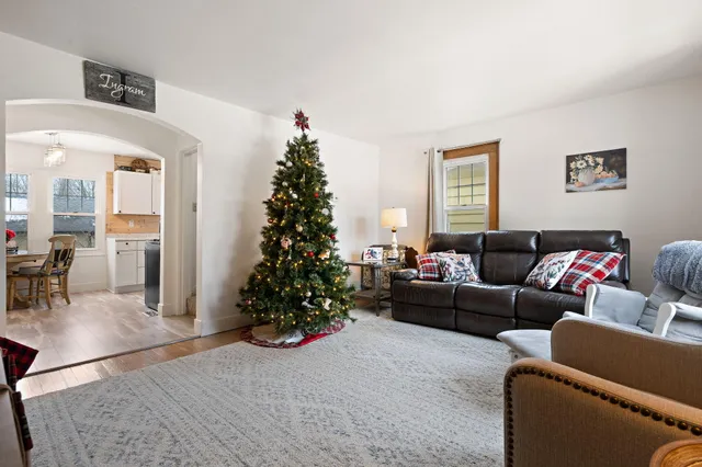 a living room with furniture and a christmas tree