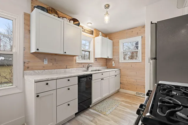 a kitchen with a sink stove and cabinets