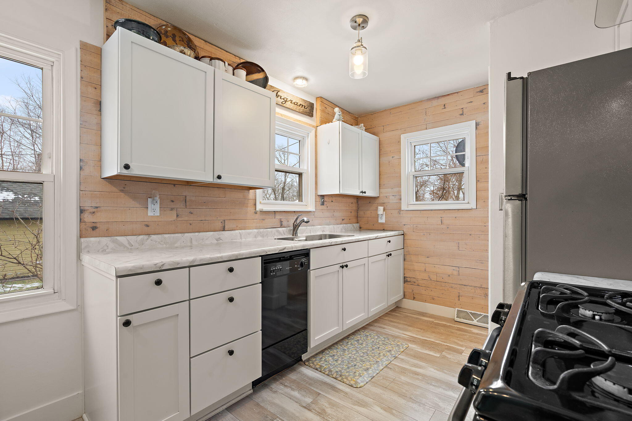 601 Azalea Street Southeast Demotte, IN 46310 - Photo 6 of 29 a kitchen with a sink stove and cabinets