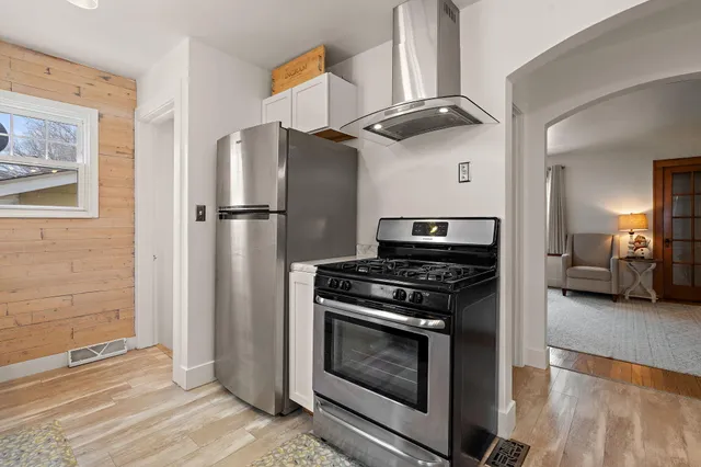 a kitchen with stainless steel appliances granite countertop a stove and a refrigerator