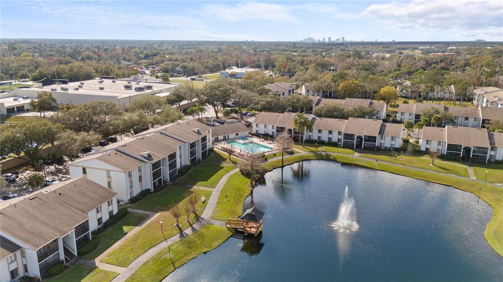 8203 Sun Spring Circle, Unit 12 Orlando, FL 32825 - Photo 2 of 38 a view of a swimming pool with outdoor seating and a mountain view