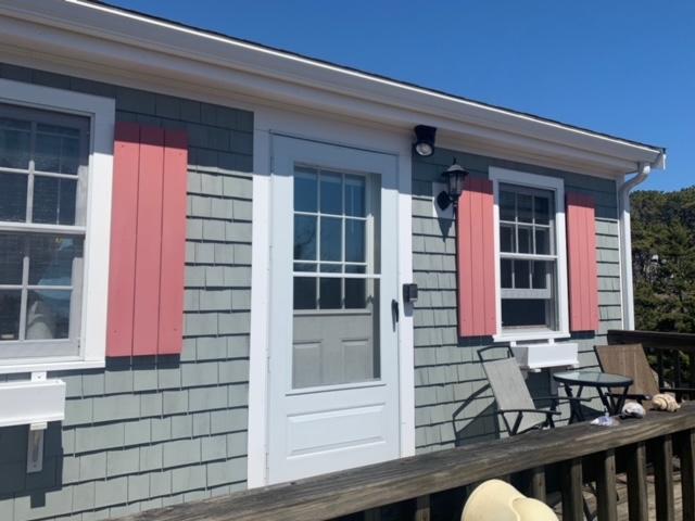 87 Massasoit Road Wellfleet, MA 02667 - Photo 7 of 26 a front view of house with a chair and door