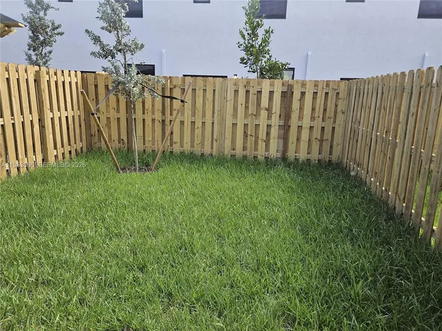 a view of a garden with a wooden fence