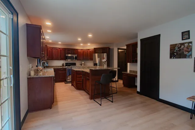 a kitchen with stainless steel appliances granite countertop a sink and cabinets