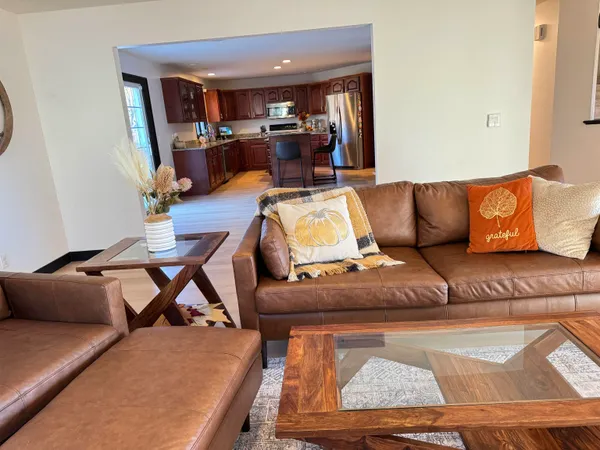 a living room with furniture a fireplace and a flat screen tv