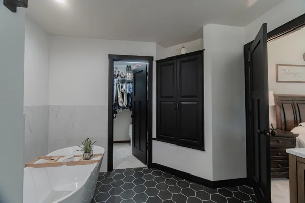 a bedroom with a bed and a lamp on table