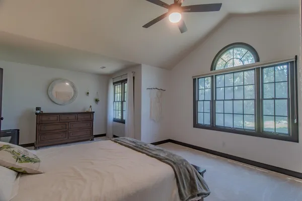 a bedroom with a bed and a table in it