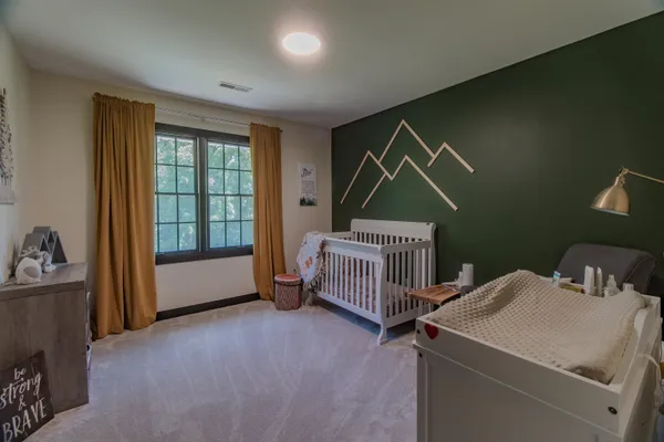 a spacious bedroom with a bed and a window