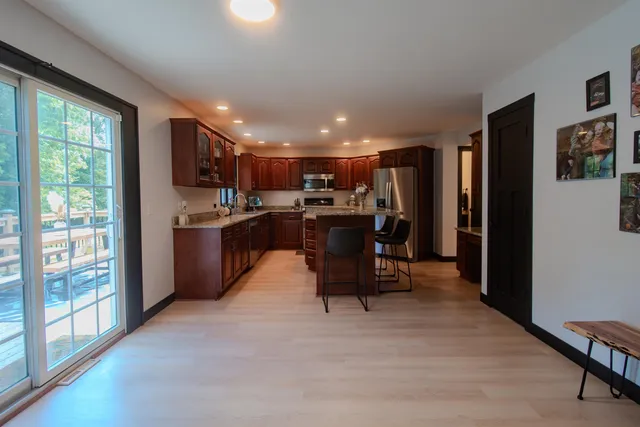 a bedroom with a bed and a chandelier fan