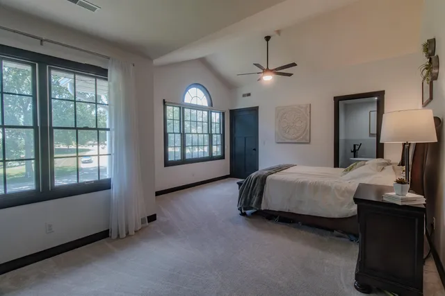 a bedroom with a bed and a window