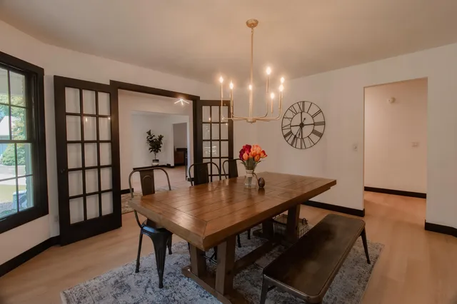 a front view of a house with a garden and trees