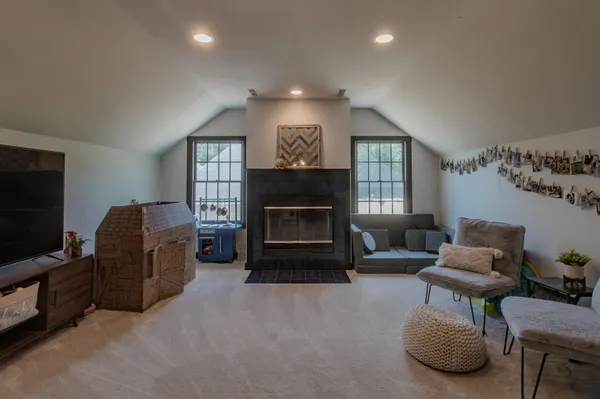 a front view of a house with a garden and trees
