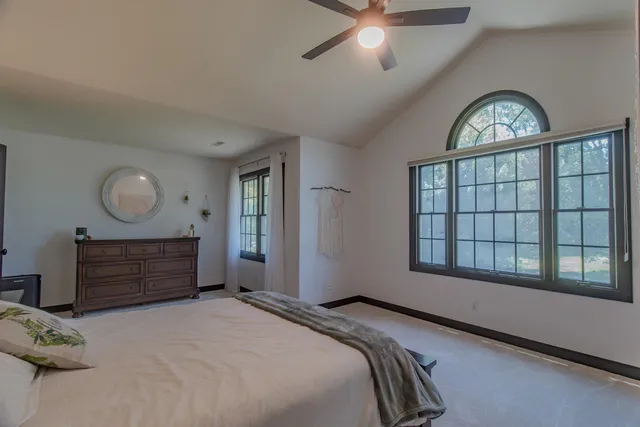 a bedroom with a bed and a chandelier