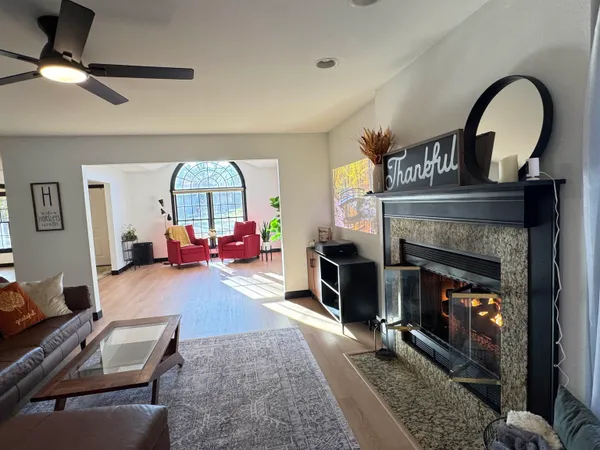 a living room with furniture a flat screen tv and a table